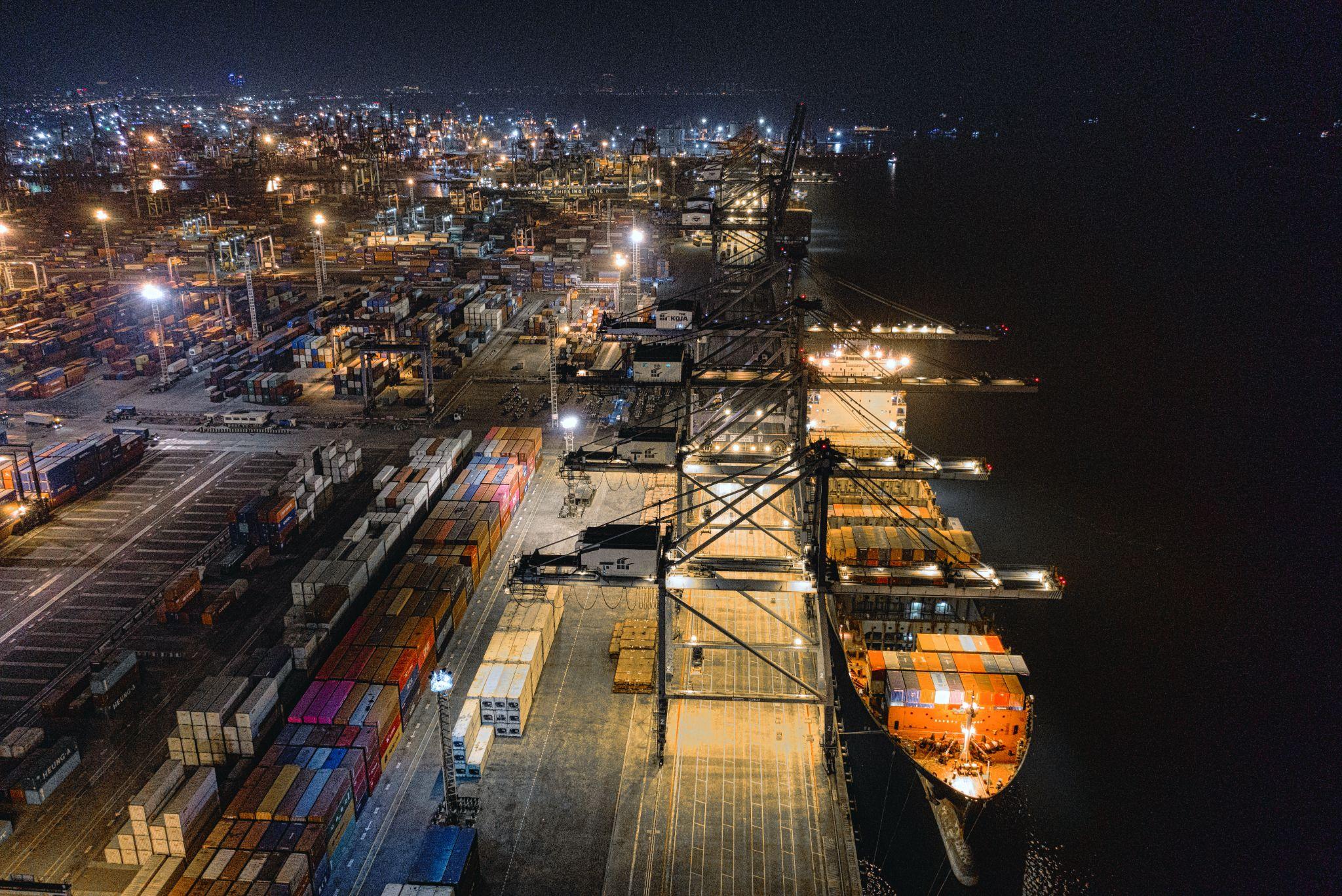 Container port at night, wide-area screening environment for SOP-4 cargo work.